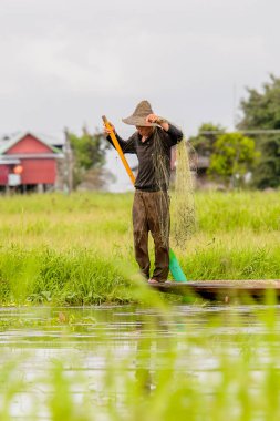 Inle Lake, Myanmar - 30 Ağustos 2016: Myanmar'ın Shan Eyaletinin Taunggyi İlçesi'nin Nyaungshwe İlçesi'nde bulunan bir tatlı su gölü olan Inle Sap'ın üzerinde bambu teknede bulunan tanımlanamayan Birmanyalı adam