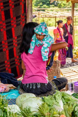 Inle Lake, Myanmar - 30 Ağustos 2016: Bir bebek ile tanımlanamayan Birmanya kadın pazar yerinde çalışır, Inle Sap, Shan State Taunggyi İlçesi Nyaungshwe İlçesi'nde bir tatlı su gölü, Myanmar