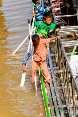 Inle Lake, Myanmar - 30 Ağustos 2016: Tanımlanamayan Birmanyalı çocuk Inle Gölü'nün iskelesinde oynuyor. Myanma halkının yüzde 68'i Bamar etnik grubuna mensandı