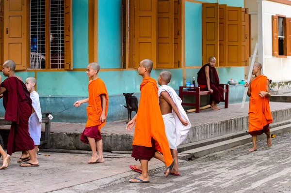 Inwa, Myanmar - 25 Ağustos 2016: Tanımlanamayan Birmanyalı genç Budist rahipler sokakta yürüyor. Myanma halkının yüzde 68'i Bamar etnik grubuna mensandı