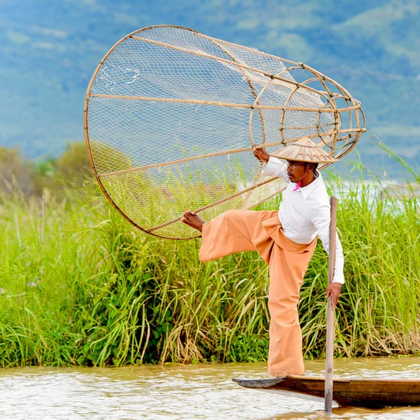 Inle Lake, Myanmar - 30 Ağustos 2016: Özel el yapımı ağı olan bir teknede tanımlanamayan Birmanyalı balıkçı. Bu Myanmar balıkçılık geleneksel yoludur