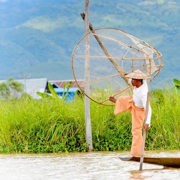 Inle Lake, Myanmar - 30 Ağustos 2016: Özel el yapımı ağı olan bir teknede tanımlanamayan Birmanyalı balıkçı. Bu Myanmar balıkçılık geleneksel yoludur
