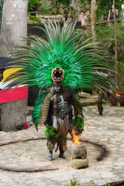 XCARET, MEXICO - NOV 8, 2015: Unidentified man wears a costume of a Maya indian. The Mayan are a group of Indigenous people of Mesoamerica clipart