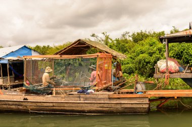 Lake Tonle Sap, Combodia - 28 Eylül 2014: Kimliği belirsiz kişiler, Güneydoğu Asya'nın en büyük tatlı su gölü olan 1997'den beri Unesco biyosferi olan Tonle Sap Gölü'nde balık ağı yapıyorlar.