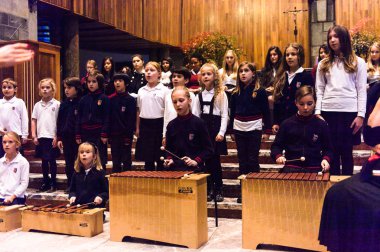 Lugano, İsviçre - 6 Aralık 2015: Kimliği belirsiz çocuklar kilisede bir Noel şarkısı söylüyor. Bilinen ilk Noel ilahileri dördüncü yüzyıl Roma'sında ortaya çıktı