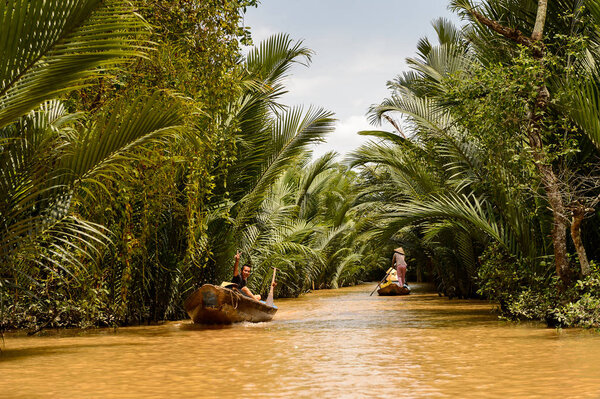 SONG NUOC MIEN TAY, VIETNAM - OCT 5, 2014: Unidentified Vietnamese people in a boat over the Mekong river. Mekong is the 12th longest river in the world