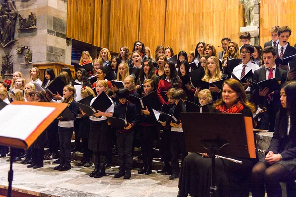 Lugano, İsviçre - 6 Aralık 2015: Kimliği belirsiz çocuklar kilisede bir Noel şarkısı söylüyor. Bilinen ilk Noel ilahileri dördüncü yüzyıl Roma'sında ortaya çıktı