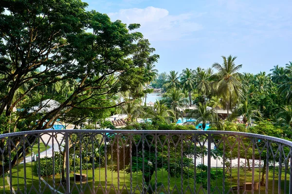 A view of garden and swimming pool from a balcony at a resort in Singapore.