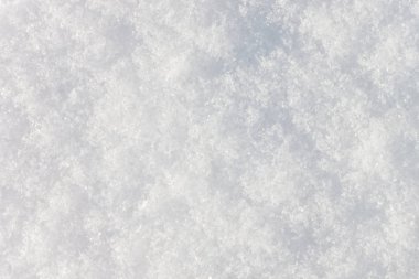 Arka plan kar yapılan bir kabartma doku var. Bir kar tanesi altıgen yıldız görülebilir.