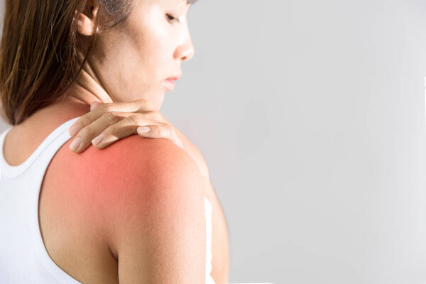 woman holding hand on skin around right shoulder joint with inflammation color 