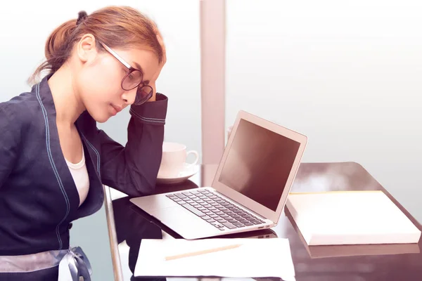 business woman touching her forehead, asian woman relax after hard work or depress in work office