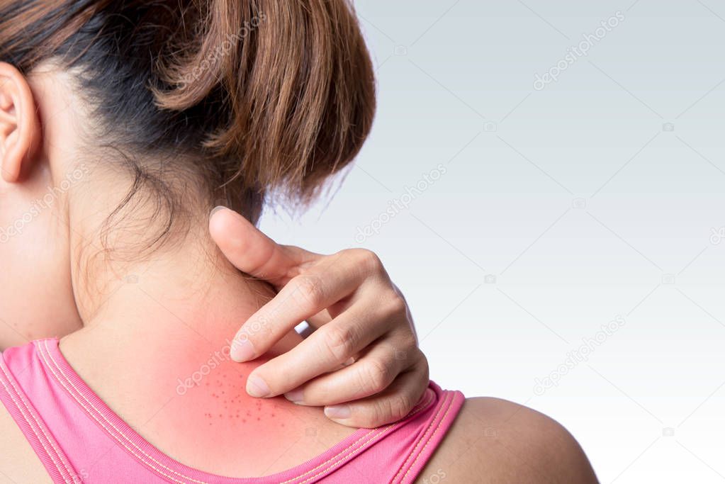 young woman scratching upper back or neck rash on white background 