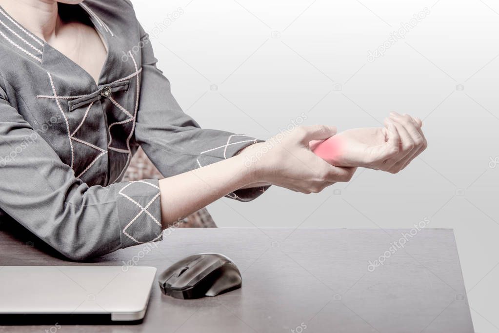 office woman pain at right wrist, case woman woking at table and pain at right wrist because of hard work, office syndrome concept 