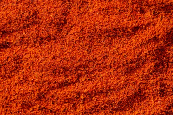 Pilha seca esmagado pimenta vermelha quente, páprica textura fundo — Fotografia de Stock