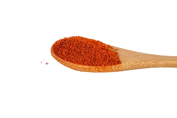 Heap of dried crushed hot red pepper on bamboo spoon. Macro — Stock Photo, Image