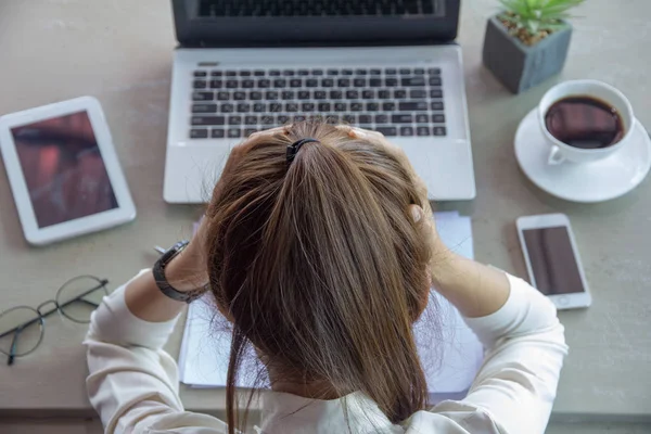 businesswoman feeling stress from work in the office