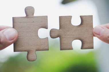 Parçalı bulmaca beyaz, ortak iş kavramları iki insan elleri bağlı.