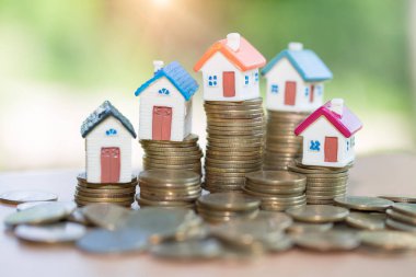 Mini house on stack of coins, Real estate investment, Save money with stack coin, Business growth investment and financial, Mortgage concept.  clipart