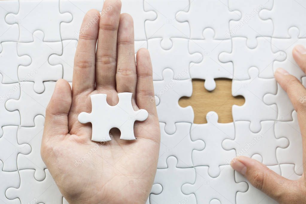 Pieces of jigsaw on palm,Pieces of jigsaw puzzle in women hands, Business solutions, success and strategy concept