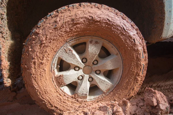 Off-road tires, Dirty offroad car, SUV covered with mud on countryside road.  offroad travel  and driving concept.