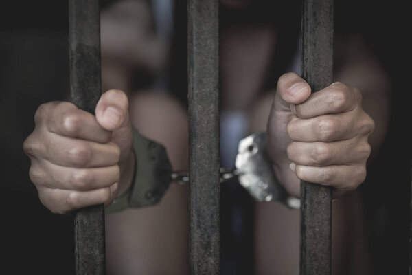 The slave girl was handcuffed and kept in a cage. Women violence and abused concept,  human trafficking Concept, international women's day.