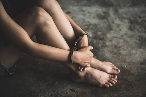 close-up of hands in handcuff,  Female prisoner, Arrested woman handcuffed hands. Prisoner or arrested terrorist, hacker, bribetaker. 