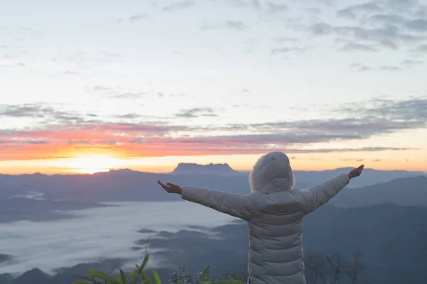 Christian woman  hands praying to god on the mountain background with morning sunrise. Woman Pray for god blessing to wishing have a better life. Christian life crisis prayer to god.