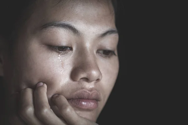 Sad depressed woman suffering and from family life. women sitting in dark room and crying, Young beautiful women thinking how to solve problem, Stop violence against women