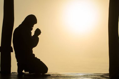 Güneş doğarken, Christian Religion kavramı arka plan Tanrı'ya dua genç insan eli silüeti.