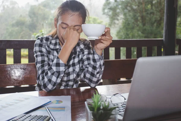 Women are stressed due to work failures, Business failure concept, Stressed businessman with head in hands at office.