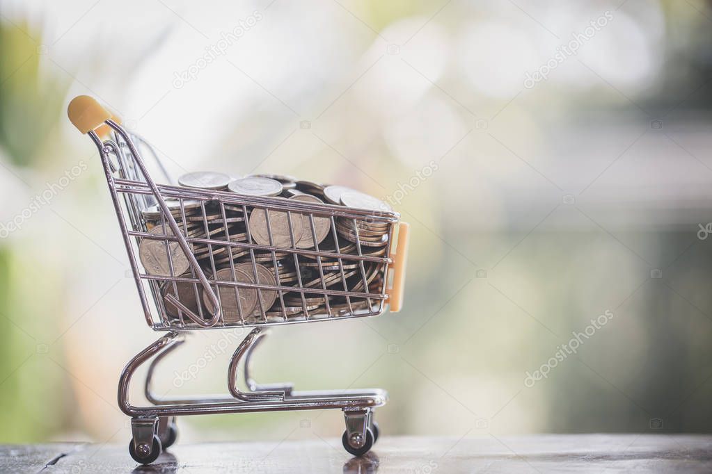 Supermarket trolley with coins, Coin in shopping cart,  concept pay spend saving money, supermarket store, Finance and money