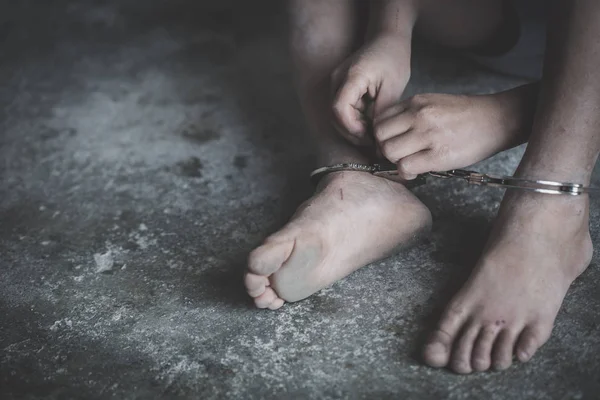 Hopeless child's foot locked with handcuffs, human trafficking, — Stock Photo, Image