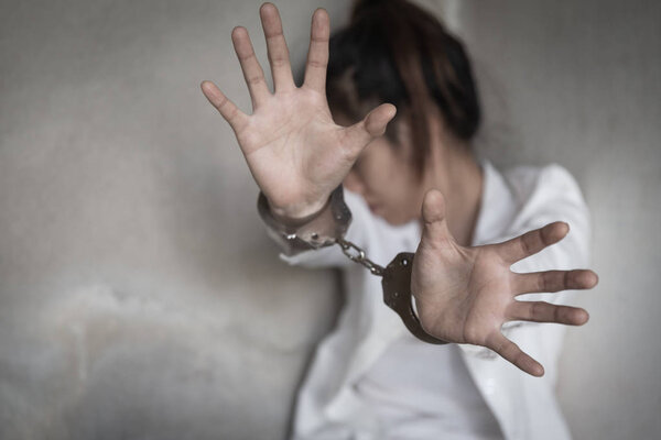 Woman's hands in handcuffs. Women violence and abused concept. h