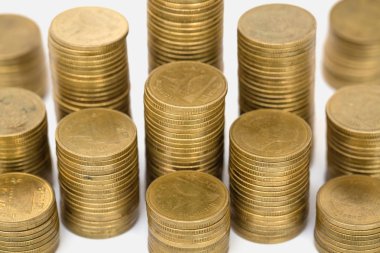  Beyaz arkaplanda izole edilmiş altın para yığınları.