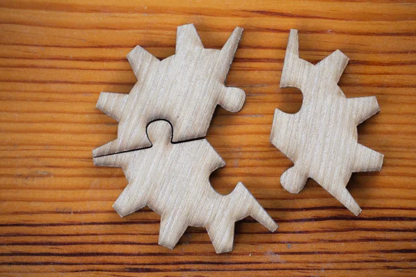 Wooden jigsaw puzzle On Wooden Desk, team business concept