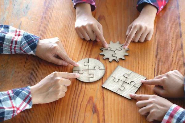 Many persons holding pieces of jigsaw puzzle,Teamwork concept,,Business connection,Success and strategy concept,Business accounting