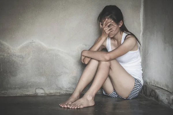 Sad woman sitting alone in a empty room . domestic violence, int