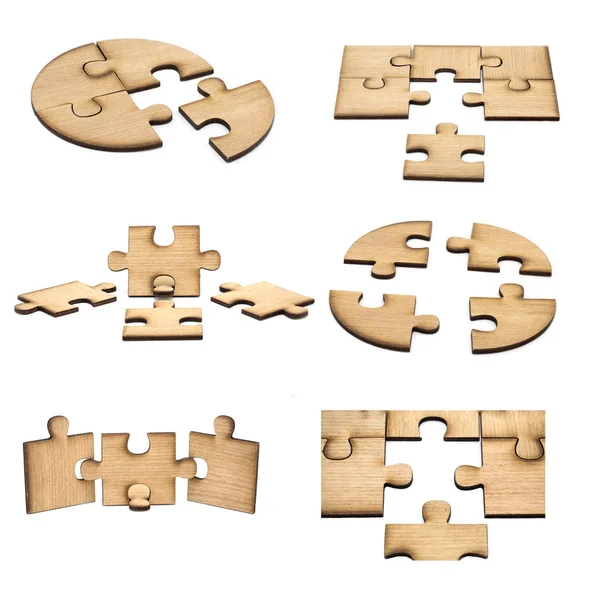 Raccolta di pezzi di puzzle in legno isolato su sfondo bianco — Foto Stock