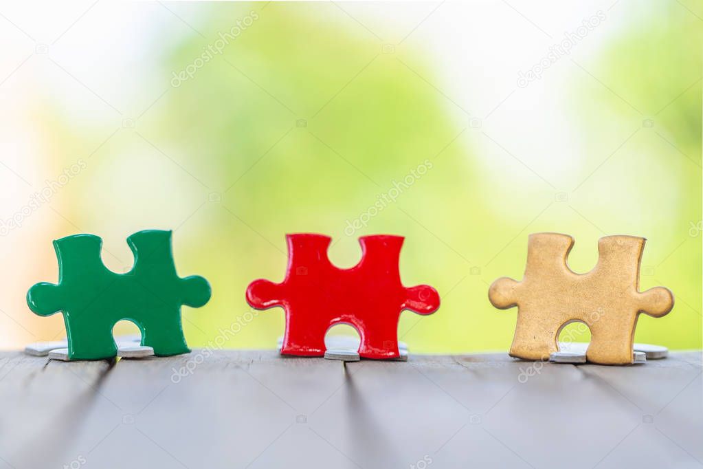 piece of Red green and gold jigsaw puzzle On the old wood And gr