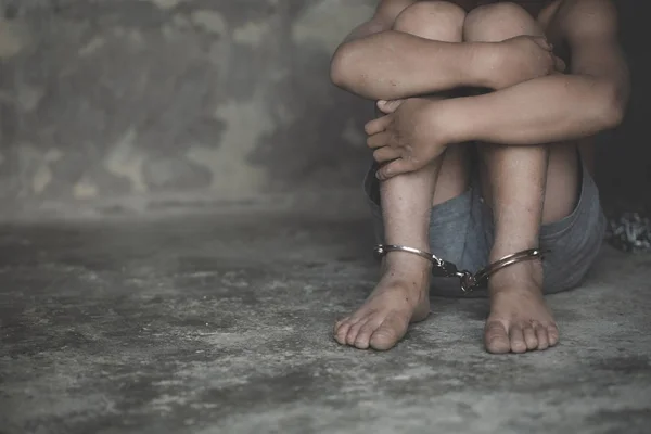 Hopeless child's foot locked with handcuffs, human trafficking, — Stock Photo, Image
