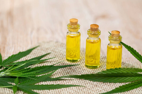 CBD oil cannabis extract, Hemp oil bottles and hemp flowers on a