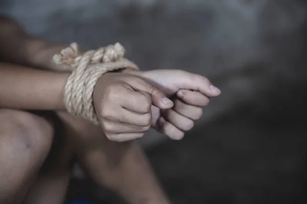 Child abuse, victim boy with hands tied up with rope in emotiona — Stock Photo, Image