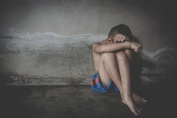 Victim boy with hands tied up with rope in emotional stress and — Stock Photo, Image