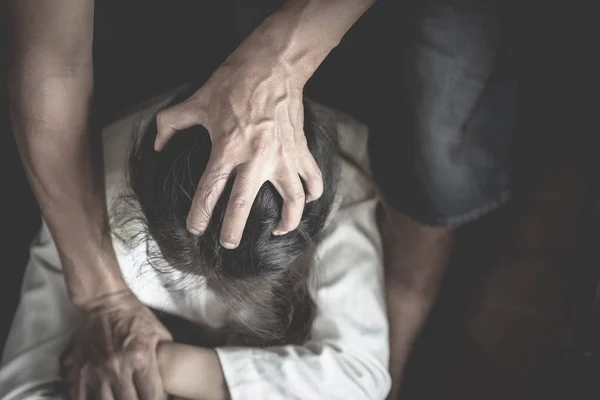 Domestic violence with a man hurting to a terrified woman  in a — Stock Photo, Image