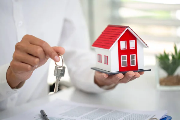 Immobilienmakler mit Hausmodell und Schlüsseln, Immobilien und Profi — Stockfoto