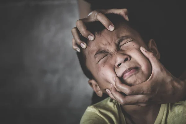 Scared  child with an adult man\'s hand covering her face. stop abusing violence,  human trafficking, stop violence against child, Stop child abuse, Child labor, Human rights violations.