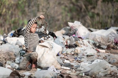 Çocuk işçiliği. Çocuklar çöp üzerinde çalışmaya zorlanıyorlar. Zavallı çocuklar çöp topluyor. Yoksulluk, Şiddet Çocukları ve Kaçakçılık Konsepti, Çocuk Hakları Günü, 10 Aralık.