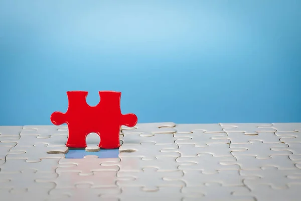 Red jigsaw puzzle. Completing final task, missing jigsaw puzzle pieces and business concept with a puzzle piece missing.