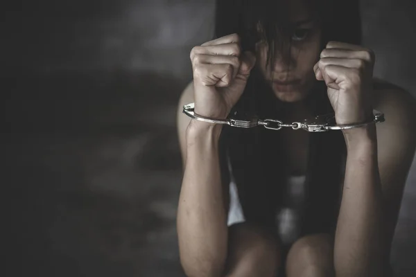 The slave girl was handcuffed and kept. Women violence and abused concept, Imprisonment, Female prisoner,  human trafficking Concept, international women\'s day.