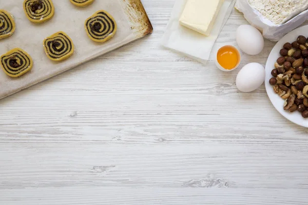 From above, unbaked raw cookies with ingredients for making cookies. Top view, flat lay. Space for text.